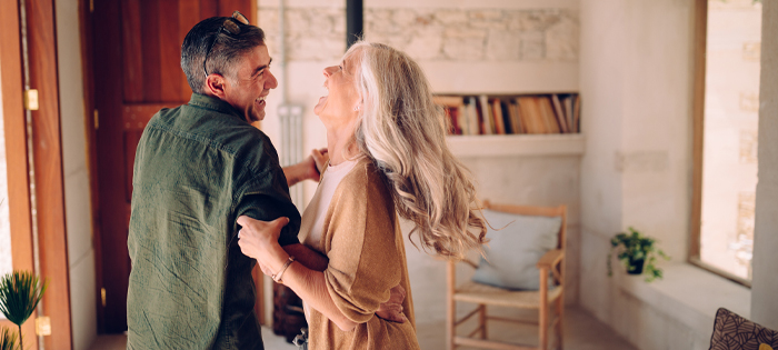 An older couple dancing happily