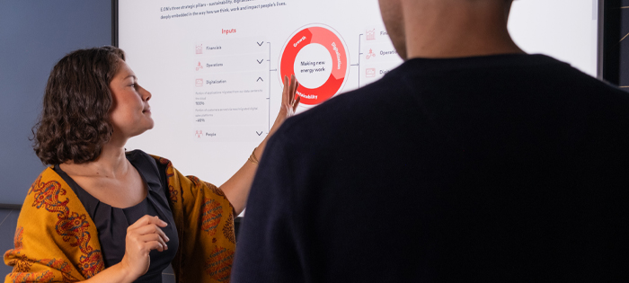 Two people looking at a red graphic on screen