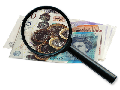 A magnifying class giving a close up of coins and money notes